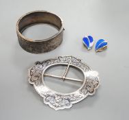 A late Victorian engraved silver hinged bangle, a white metal and niello buckle and a pair of mid