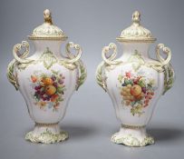 A pair of Copelands London, fruit decorated two handled vases and covers, circa 1900- 20 cms high.