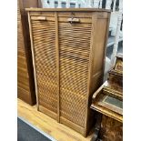 A mid century oak double tambour filing cabinet, width 87cm depth 38cm height 143cm