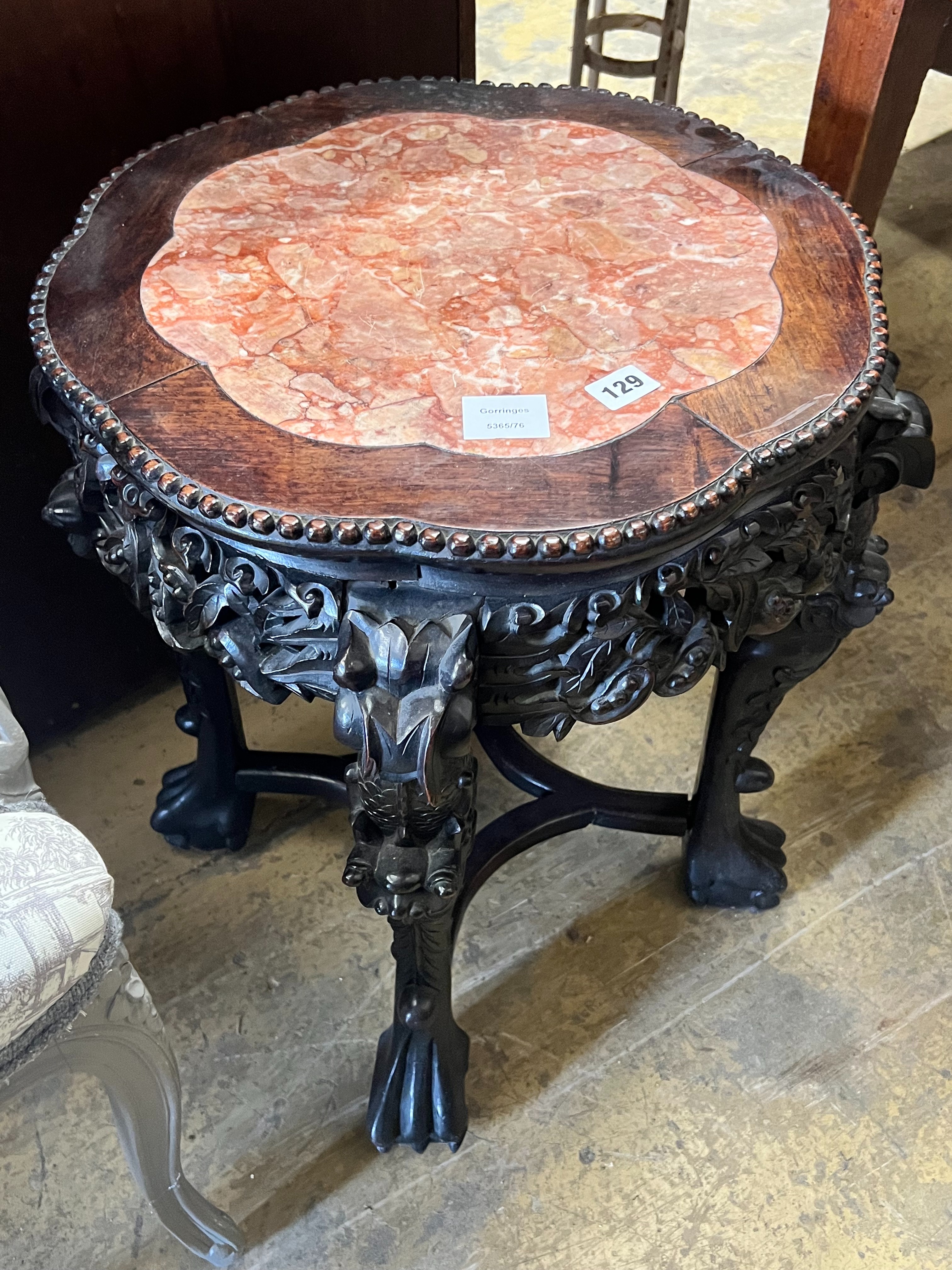 A Chinese carved hongmu circular marble topped jardiniere stand, diameter 46cm height 58cm