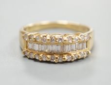 A modern 18ct gold and three row baguette cut diamond and diamond chip set half hoop ring, size M,