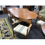 A 1950s teak Danish extending dining table and six chairs, two with arms, table extended 229cm,