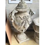A large reconstituted stone lidded garden urn, with mermaid motif and floral swagged body, height