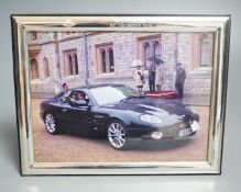 A modern Italian 925 mounted photograph frame, engraved with the Aston Martin Owners Club emblem and