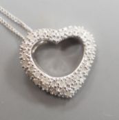 A modern 375 white metal and diamond chip set open work heart shaped pendant, 15mm, on a375 fine