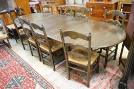 A French style oak extending dining table, with two spares leaves, 280cm extended, width 11cm,