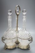 A Victorian plated decanter stand and three cut glass decanters,34 cms high.