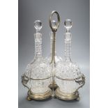 A Victorian plated decanter stand and three cut glass decanters,34 cms high.