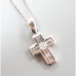 A modern 18ct white gold, baguette and princess cut diamond set cross pendant, 14mm, on an 18ct