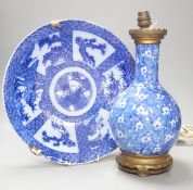 A Japanese prunus blue and white vase now as a lamp, together with a blue and white charger, 34cm