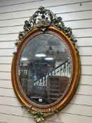 A late 19th century French oval giltwood and gesso wall mirror, later painted, width 81cm height