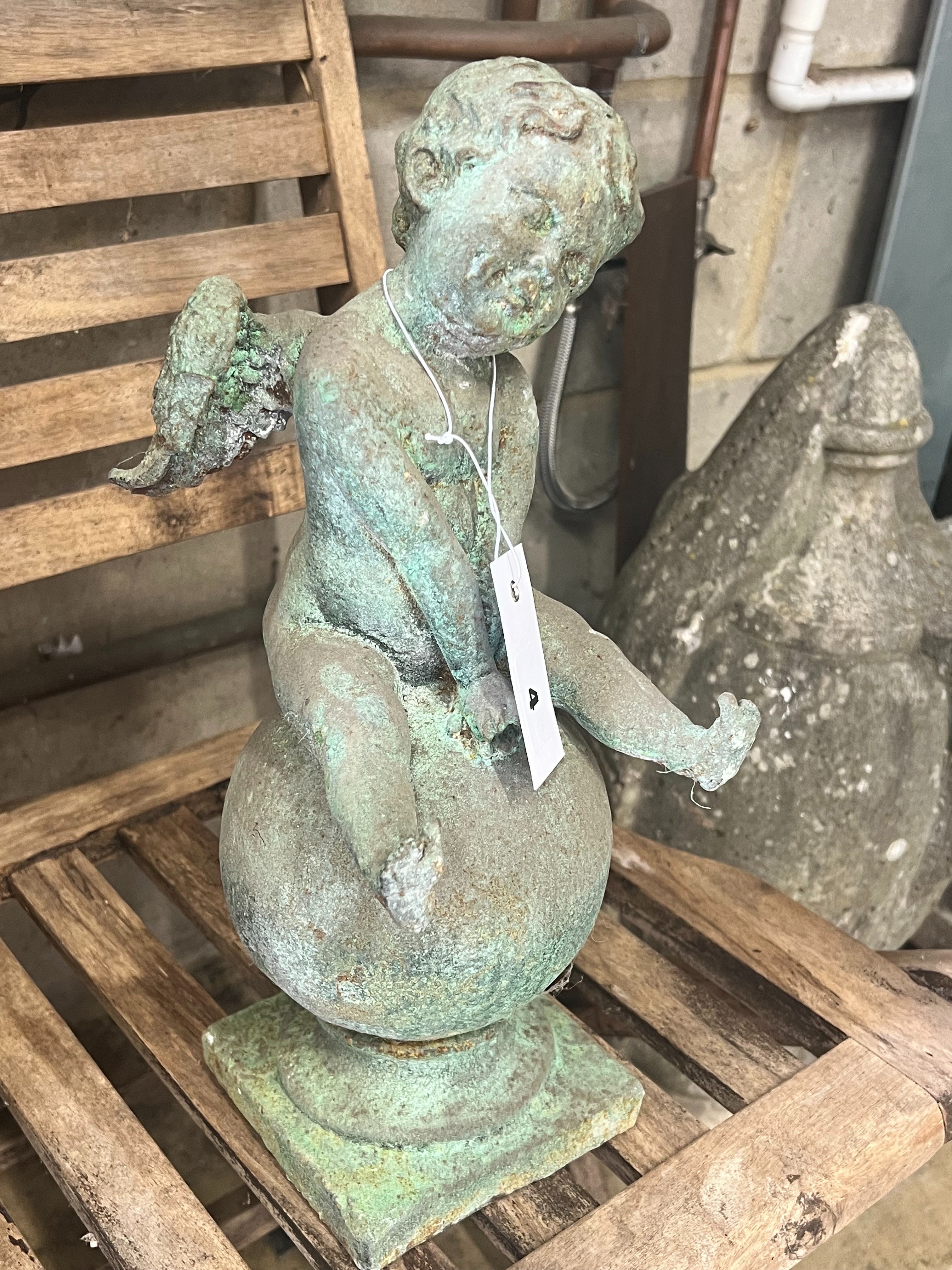 A cast iron cherub and orb garden ornament, height 38cm - Image 3 of 6