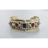 A modern parcel gilt silver and gem set open work bangle by Michael Allen Bolton, London, 1993,