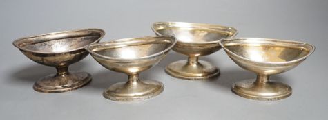 A set of four George III silver boat shaped pedestal salts, London, 1799, maker's mark rubbed,