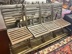 A set of eight teak folding garden chairs