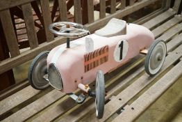 A child's sit-on toy racing car
