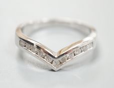 A modern 18ct white gold and channel set eleven stone diamond chip set herringbone shaped ring, size