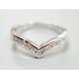 A modern 18ct white gold and channel set eleven stone diamond chip set herringbone shaped ring, size