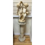 An Italian alabaster carving of bacchic cherubs on fluted pedestal, overall height 130cm