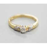 A modern 18ct gold and single stone diamond ring, with diamond chip set 'crossover' shoulders,