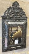 A Dutch brass framed cushion wall mirror, with ornate arched cresting, pierced and repousse with