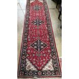 A North West Persian style red ground blue field runner, 280 x 78cm