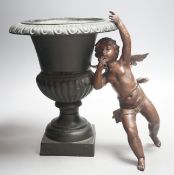 A bronzed cherub figure and a cast iron urn- 27cms high.