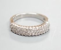 A modern 18ct white gold and three row diamond chip set half hoop ring, size K/L, gross weight 4.2