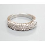 A modern 18ct white gold and three row diamond chip set half hoop ring, size K/L, gross weight 4.2