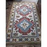 A Caucasian design ivory ground carpet, 270 x 170cm