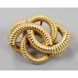 A late Victorian textured interwoven hollow yellow metal brooch, 32mm, gross 7.7 grams.