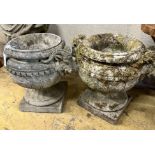 A pair of reconstituted stone circular rams head garden urns, width 50m height 46cm