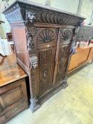 A Jacobean revival carved oak press cupboard, width 115cm depth 63cm height 156cm