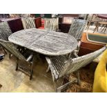 A weathered teak oval extending garden table, extended 250cm width 109cm height 73cm, and six