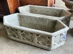 A pair of Gothic style reconstituted stone garden planters of elongated hexagonal form, width 88cm