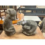 Two reconstituted stone otter garden ornaments, tallest 40cm
