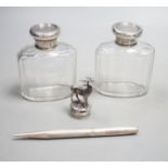 A white metal stag mounted bottle top,48mm, a pair of Edwardian silver topped glass toilet jars