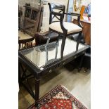 A painted mirrored three drawer ebonised writing table, length 140cm, depth 64cm, height 76cm