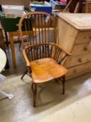 A Windsor elm and beech comb back elbow chair with crinoline stretcher, width 59cm, depth 44cm,