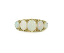 An 18ct gold and graduated five stone opal half hoop ring, with diamond chip spacers, and carved