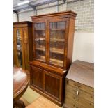 A Victorian mahogany bookcase cupboard width 118cm, depth 49cm, height 217cm.