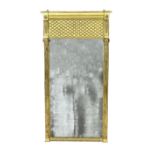 A Regency giltwood pier glass, with lattice work frieze over a rectangular plate flanked by fluted