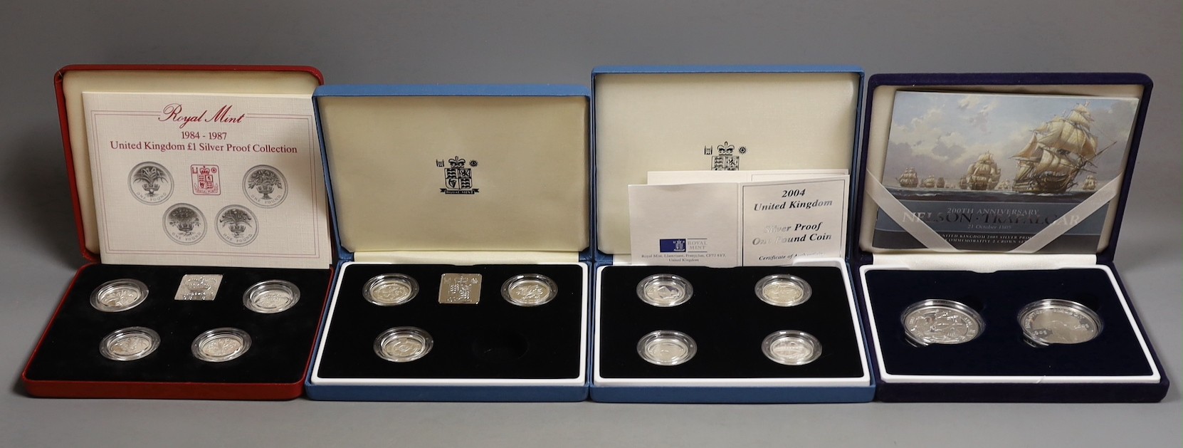 Three cased Royal Mint UK silver proof £1 coin collections 1984-87, 1994-96, 2004-07 and a 200th