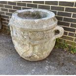 A large circular reconstituted stone garden planter with moulded serpent armorial, diameter 66cm,