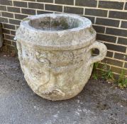 A large circular reconstituted stone garden planter with moulded serpent armorial, diameter 66cm,