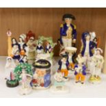 A large group of Staffordshire pottery figures and groups and figural cruets, to include a Nelson