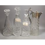 Three various cut glass decanters and a silver plated claret jug-Claret jug 26 cms high.