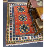 A Caucasian design red ground rug, 200 x 129cm