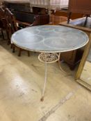 A circular painted wrought iron glass top garden table, diameter 92cm, height 76cm.
