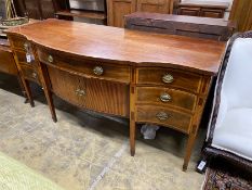 A George III satinwood banded mahogany serpentine sideboard with central tambour compartment width